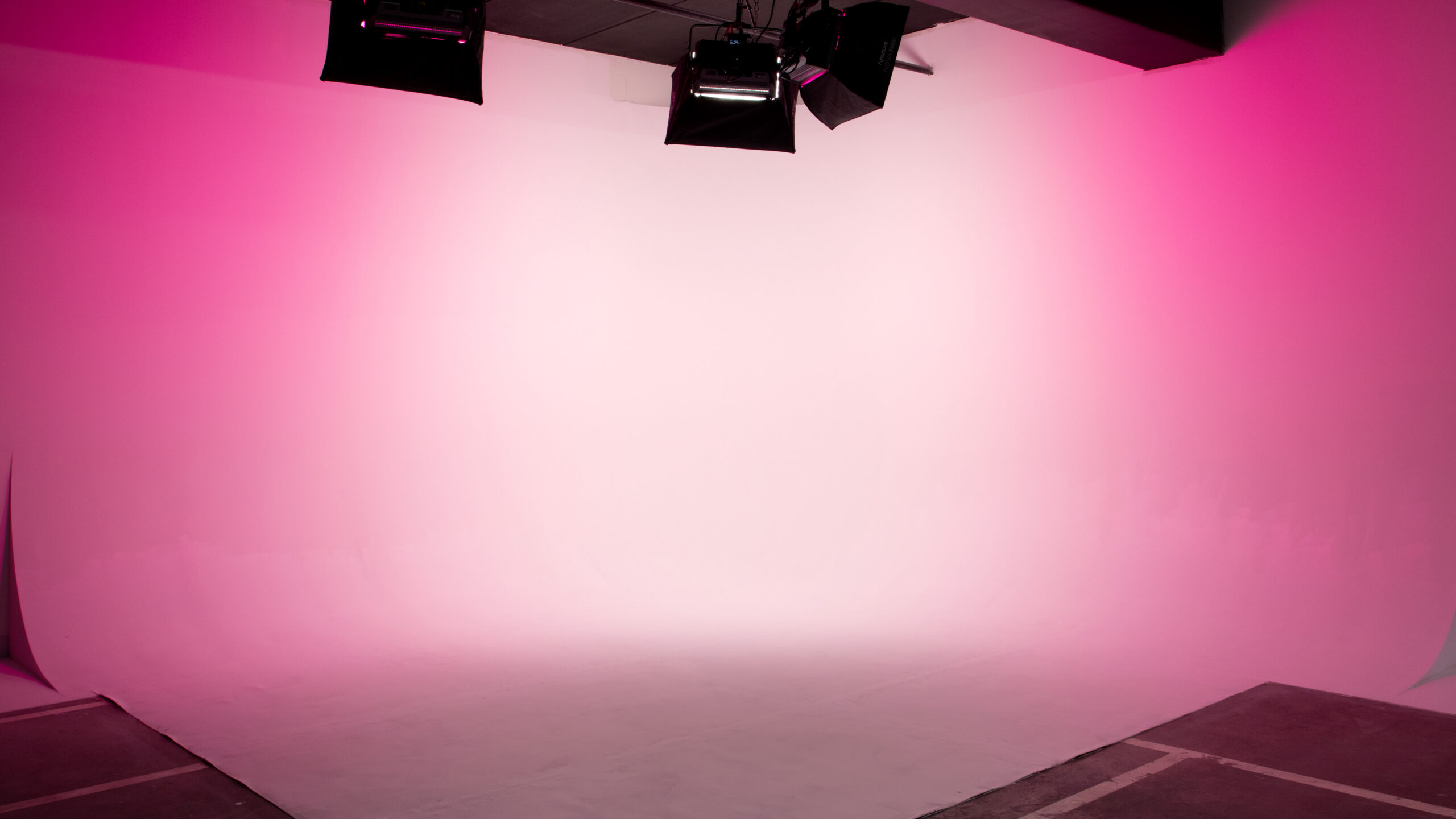 Photo of Cyc Studio, a 15x15 cyclorama cove with pink lights illuminating