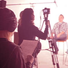 Crew Behind the Scenes Rockstoria Studios Minnesota Person reads script behind the camera taking part in filming and interview. Rockstoria Studios Minnesota Student Mentorship Program