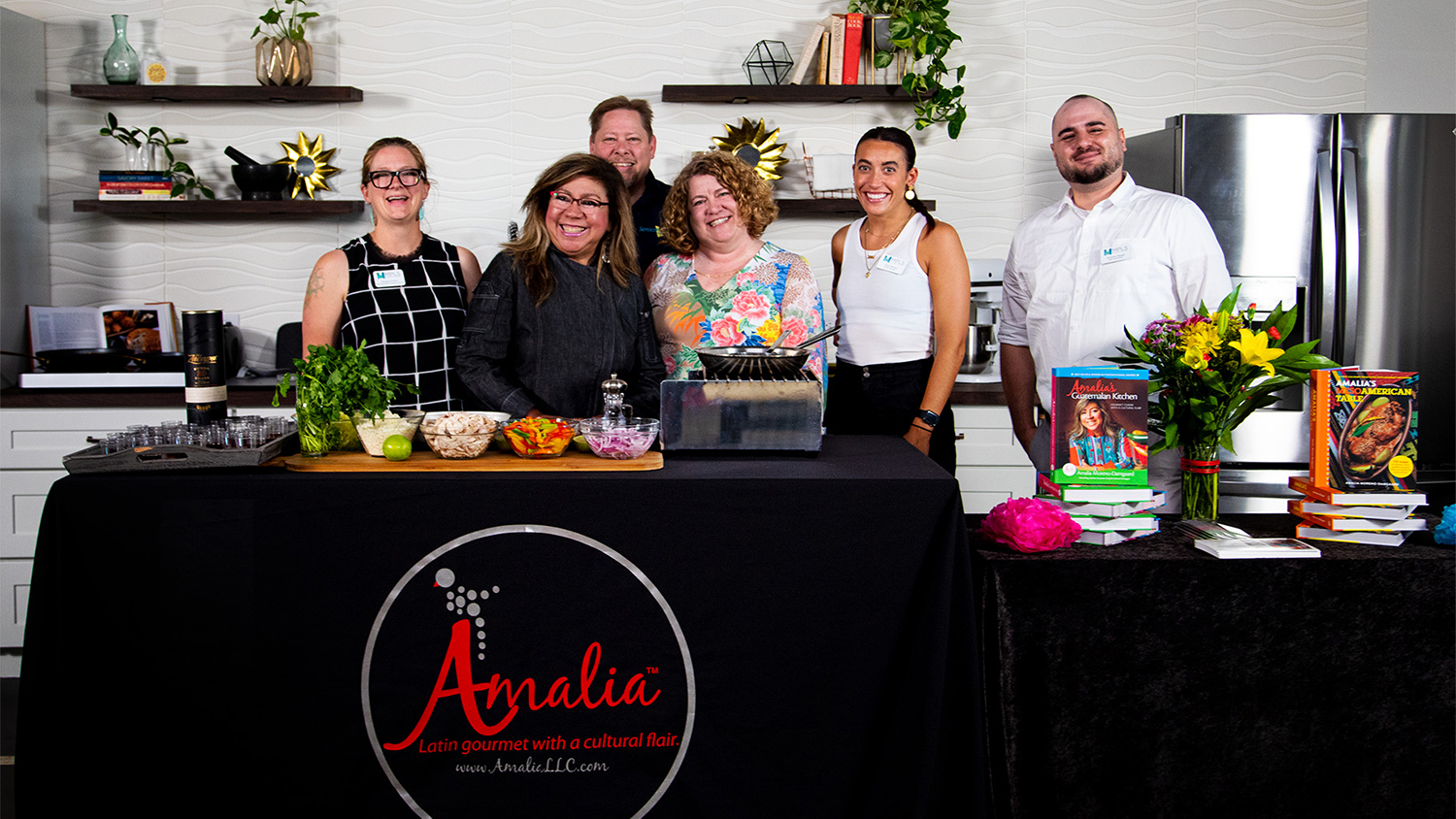 Chef Amalia Moreno-Damgaard with group for an event renting the Kitchen Studio at Rockstoria Studios Minnesota. Cookbook and cooking demo.